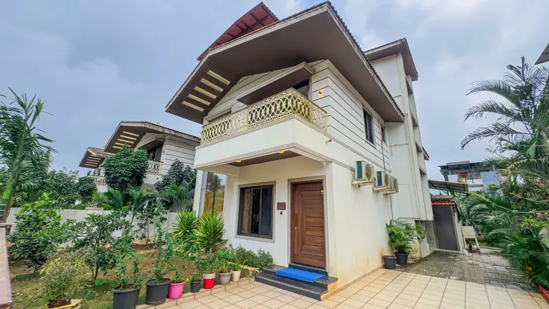 Villa exterior with garden and potted plants