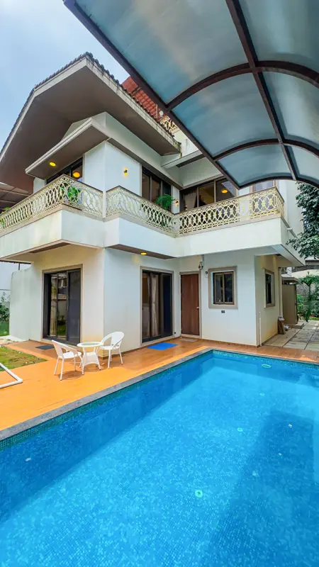 Private pool beside the villa with a covered deck